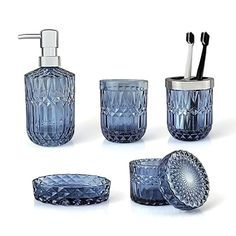 blue glass bathroom accessories including toothbrush holder, soap dispenser and cup