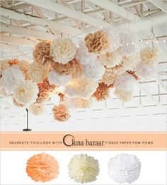 some white and orange tissue flowers hanging from the ceiling in a room with wooden beams