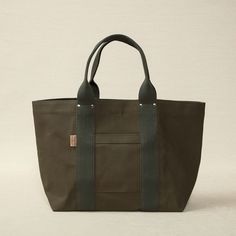 Heavy weight canvas tote 21.6" x 6.7" x 12.6" made in Japan Threadline is a Japanese-manufactured line of heavy canvas bags designed for everyday use. Khaki Canvas Bag For On-the-go, Large Capacity Duck Canvas Bag For On-the-go, Cotton Shoulder Bag With Top Handle For Errands, Practical Duck Canvas Bag For Everyday Use, Canvas Bag With Reinforced Double Handles, Cotton Canvas Bag With Leather Handles For Errands, Duck Canvas Tote Bag With Reinforced Handles, Rectangular Canvas Bag With Reinforced Handles, Waxed Canvas Tote With Reinforced Handles