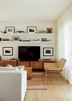 a living room filled with furniture and a flat screen tv