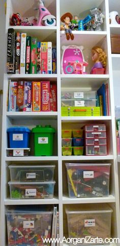 a white bookcase filled with lots of toys