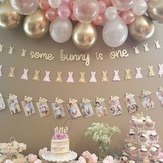 some bunny is one birthday party decorations and desserts on a table with balloons, bunnies, cake and cupcakes