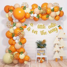 an orange themed party with balloons and decorations