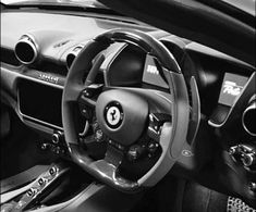 the interior of a sports car is shown in black and white, with an automatic steering wheel