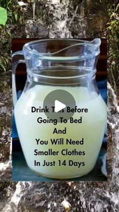 a glass jar filled with milk sitting on top of a counter next to a tree