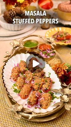 masala stuffed peppers on a platter with other food items in the back ground