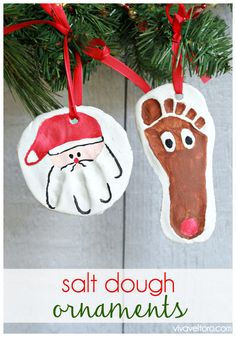 two handprinted ornaments hanging from a christmas tree with the words salt dough ornaments on them