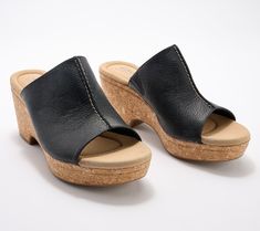 A leather upper and a cork-wrapped wedge make these gorgeous slides a must-have for fun in the summer sun. From Clarks Footwear. Casual Cork Slides For Summer, Cork Slides For Summer Beach, Casual Cork Wedge Sandals For Vacation, Comfortable Cork Slides For Summer, Cork Slides For Summer, Casual Cork Wedge Sandals With Leather Footbed, Vacation Slip-on Wedge Sandals With Cork-bed Midsoles, Beach Wedge Sandals With Cork-bed Midsoles, Adjustable Cork-bed Wedge Sandals For Beach