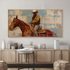 a painting of a cowboy riding a horse on the wall above a table and chairs