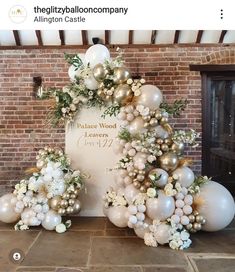 balloons and flowers are arranged in front of a sign