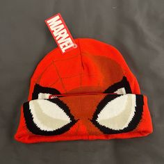 the beanie has been made to look like spider - man's face and is on display