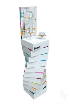 a stack of multicolored boxes sitting on top of each other in front of a white background