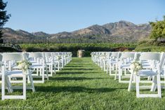 rows of white chairs set up for an outdoor ceremony