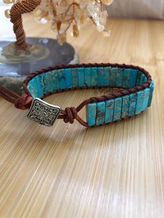 Ethically handmade products.  Great for meditation, intentions, birthday gifts.  Adjustable leather bracelet with different length knot to adjust. Made with natural stones, alloy,  boho/hippie style bracelet,  lead-free, nickel free. Please note:  because of the natural stones colors, each bracelet will be unique in its own way.   Kingman Turquoise is a protective stone that promotes well-being, spiritual attunement, and emotional balance. As a result, Kingman turquoise is sometimes used in holi Adjustable Leather Bracelets With Natural Stones, Handmade Adjustable Spiritual Leather Bracelet, Adjustable Hand-strung Leather Bracelet, Leather Bracelets With Natural Stones For Gifts, Adjustable Hand Wrapped Spiritual Leather Bracelet, Bohemian Leather Bracelet With Natural Stones For Gift, Handmade Leather Beaded Spiritual Bracelets, Bohemian Leather Bracelet With Natural Stones As Gift, Handmade Leather Beaded Bracelets Spiritual Style