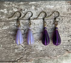 ✦Long deep deep purple or lavender purple/Bronze drop bohemian Czech glass with gold spacer, purple rondelle bead, topped with gold bead on earrings. ✦These boho beauties dangle 51mm from the top of nickel free brass ear wires. Width 10mm. ✦Option of deep purple or Lavender purple earrings. For all free spirited women who want to enjoy their unique style! 100% artisan made. Hypoallergenic Purple Dangle Teardrop Earrings, Purple Dangle Teardrop Earrings With Ear Wire, Purple Nickel-free Teardrop Dangle Earrings, Purple Long Drop Earrings With Ear Wire, Purple Drop Earrings With Ear Wire, Hypoallergenic Purple Bohemian Earrings, Purple Dangle Teardrop Earrings Gift, Purple Czech Glass Drop Earrings, Bohemian Purple Earrings With Czech Glass