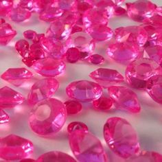 many pink diamonds on a white surface