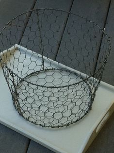 a chicken wire basket sitting on top of a white tray