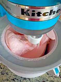 a kitchen aid mixer with pink food inside of it