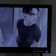 a television screen with the image of a young man on it's display surface