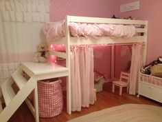 a white bunk bed sitting in a bedroom next to a desk