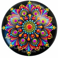 a black plate with colorful designs on it