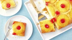 pineapple upside down cake on a plate with a fork and two plates next to it