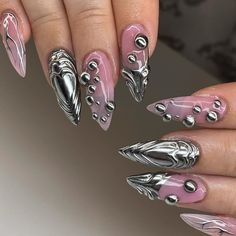 "Metallic Majesty" Press-On Nail Set by Jerry Nails 🌑🔗 Unleash your inner strength with the "Metallic Majesty" Press-On Nail Set, an embodiment of power and elegance. This collection marries the boldness of metal with the subtlety of art, perfect for anyone who loves to make a statement with their style.  Key Features & Highlights: 🔩 Sculpted Metallic Accents: Each nail features unique metallic sculptures that catch the light and eyes alike. These high-shine elements are designed to mimic the flow of molten metal, solidified into stunning patterns. 🌑 Polished Metal Finish: The nails boast a mirror-like metallic finish that provides a sleek and sophisticated look, reflecting your surroundings and enhancing the depth of the design. 🔗 Intricate Beadwork: Embellished with carefully placed Silver Pink Chrome Nails, Aluminum Nail Design, Silver Bubble Nails, 3d Nail Chrome, Chrome Y2k Nails + Charms, Sculptured Nails Acrylic, Metallic 3d Nails, Chrome 3d Nails Designs, Crome Nails Oval