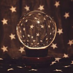 a snow globe sitting on top of a wooden stand in front of an american flag