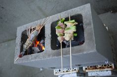 food is being cooked on the grill with skewered vegetables and meats in it