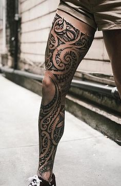 a man with tattoos on his legs and leg