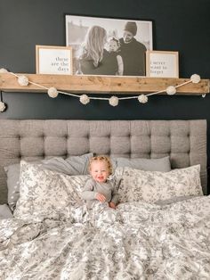 a little boy laying in bed with his hands on his chest and looking at the camera