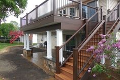 a house with a deck and stairs leading up to the front door