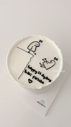 a white cake with black writing on it