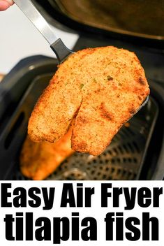 the air fryer has two pieces of bread in it and is being held by a spatula