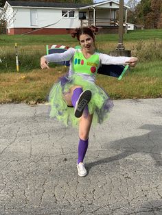 a woman in a costume is dancing on the street