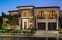 this is an image of a two story house at night with lights on the windows