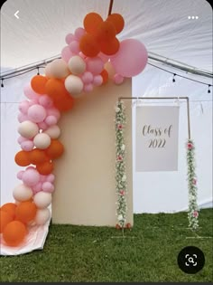 an arch made out of balloons and flowers