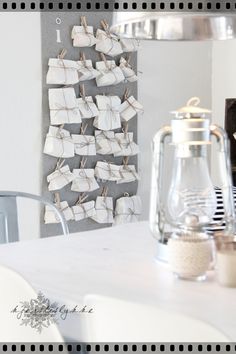 a white table topped with a glass vase filled with water and marshmallows