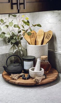 wooden utensils and spoons are on a cutting board