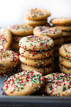 a tray full of cookies with sprinkles on them