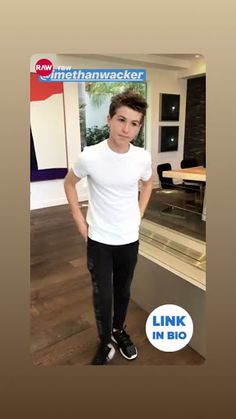 a young man standing in front of a kitchen counter with his hands on his hips