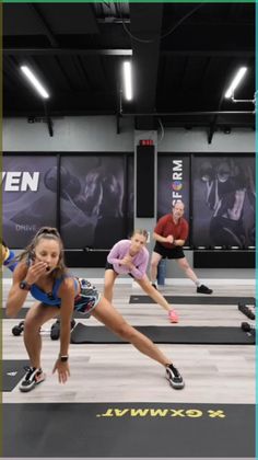 a group of people in a gym doing push ups on their stomachs and knees