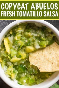 a bowl full of salsa with tortilla chips in it and the words copycat abuelos fresh tomato salsa