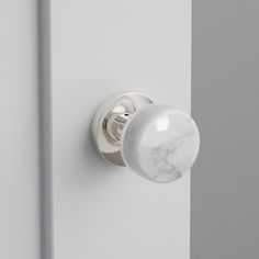 a white door with a marble knob on it