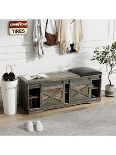 a wooden bench sitting on top of a hard wood floor next to a white wall