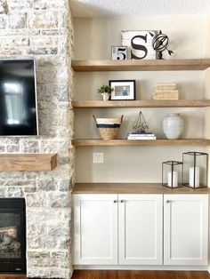 a living room filled with furniture and a flat screen tv on top of a wooden shelf