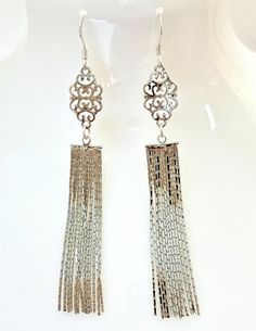 Silver Extra Long Fillagree Tassel Earrings. Lovely exquisite extra long silver earrings featuring multiple strands of chain. They will add individuality and elegance to your every day look. ♥ Details 14kt Silver Metal Long Tassels 125mm 14kt Sterling Silver Ear Wires The earrings come saftely packaged in a gift bag ready for giving. Long Silver Earrings, Fringe Earrings, Long Chain, Tassel Earrings, Ear Wires, Earrings For Women, Extra Long, Gift Bag, Favorite Jewelry