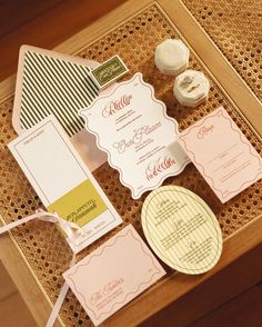 the wedding stationery is laid out on top of a wooden box with ribbon and buttons