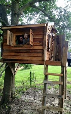 there is a tree house with two people in it