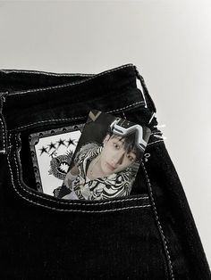 the back pocket of a pair of black jeans with an image of a man's face on it